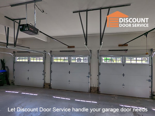Three single car garage doors installed by Discount Door Service